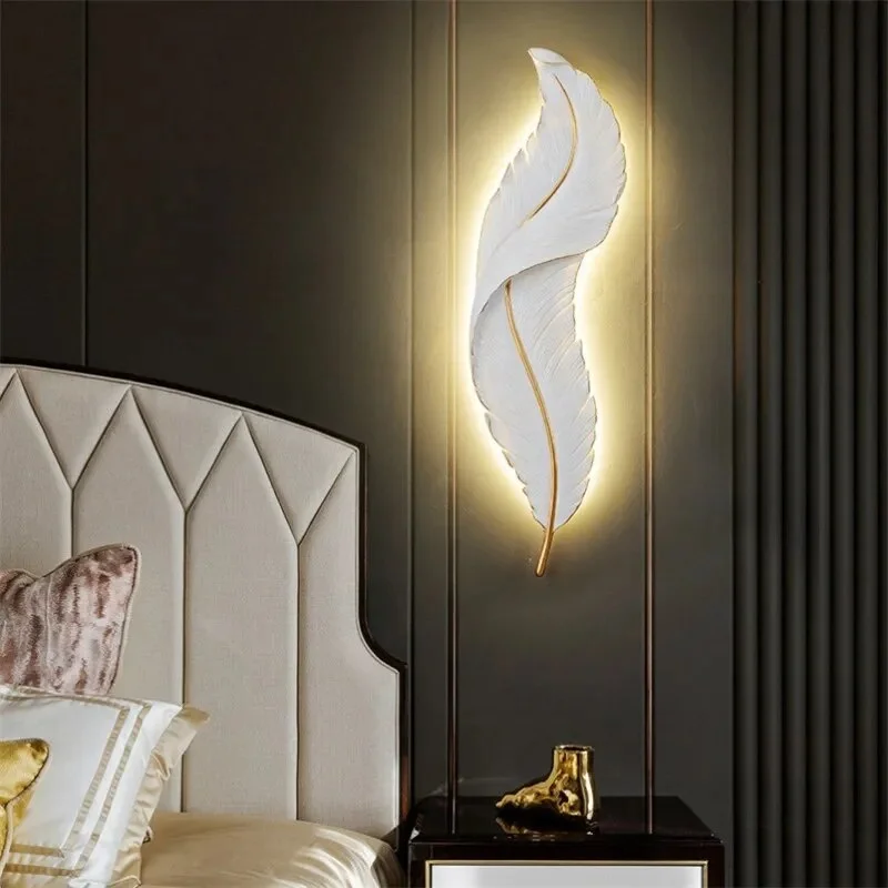 A white feather wall light to decorate the dark and dull black wall